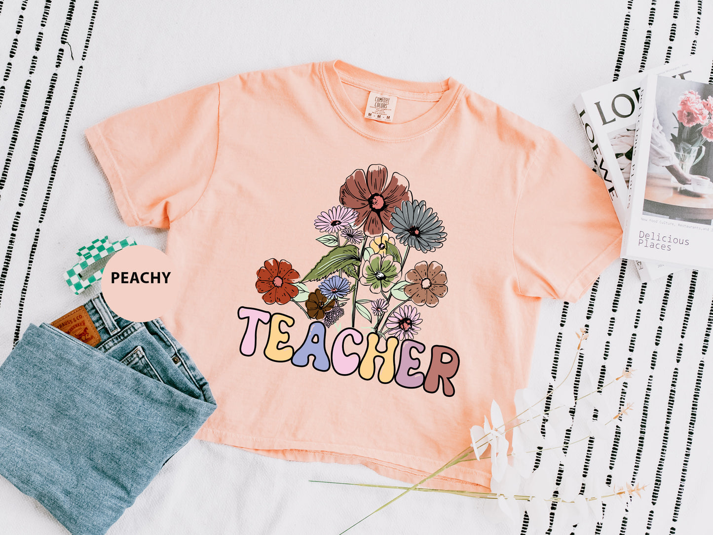 a t - shirt that says teacher with flowers on it