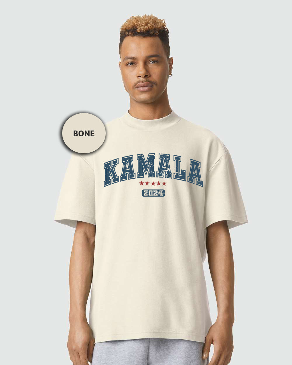 a man wearing a white shirt with the word kaamala printed on it