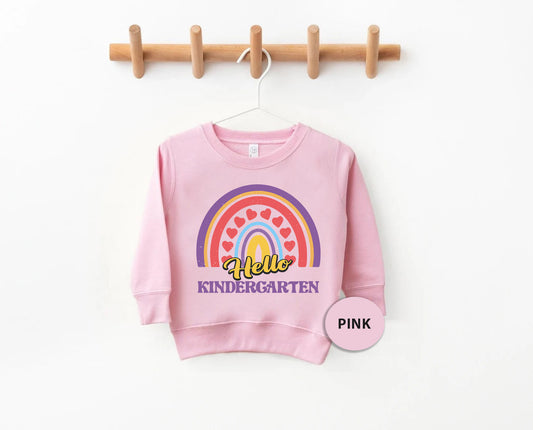 a pink sweatshirt hanging on a clothes rack