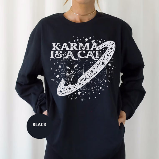 a woman wearing a black karmia is a cat sweatshirt