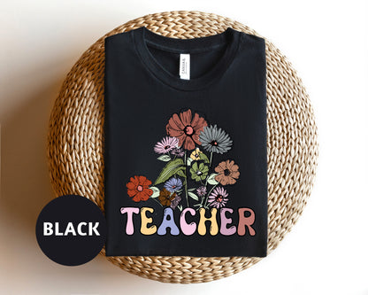 a black teacher shirt with flowers on it