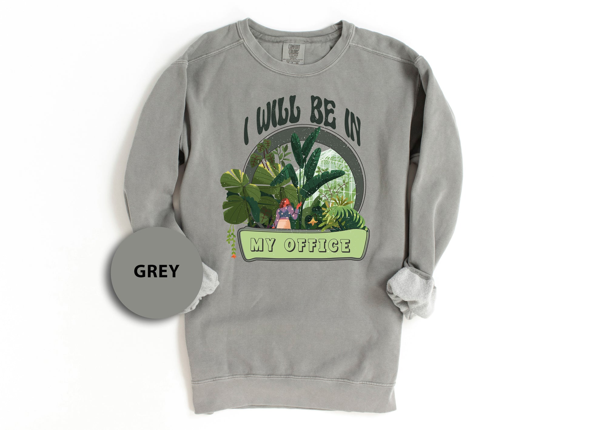 a grey sweatshirt with a picture of a woman in a garden