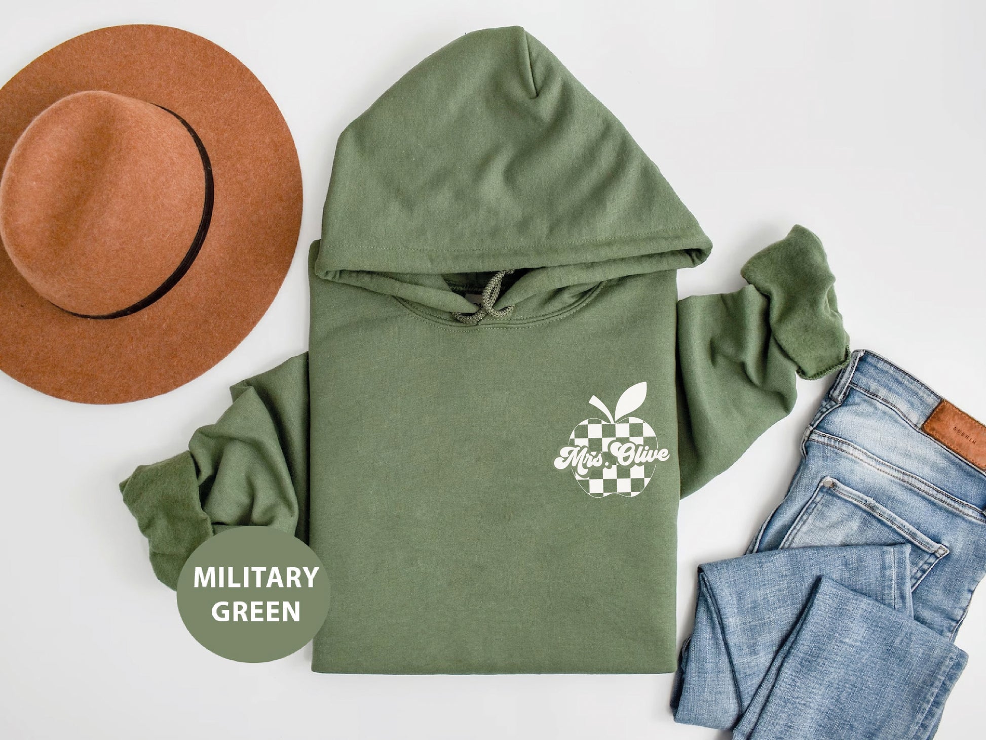 a military green hoodie with a hat and jeans