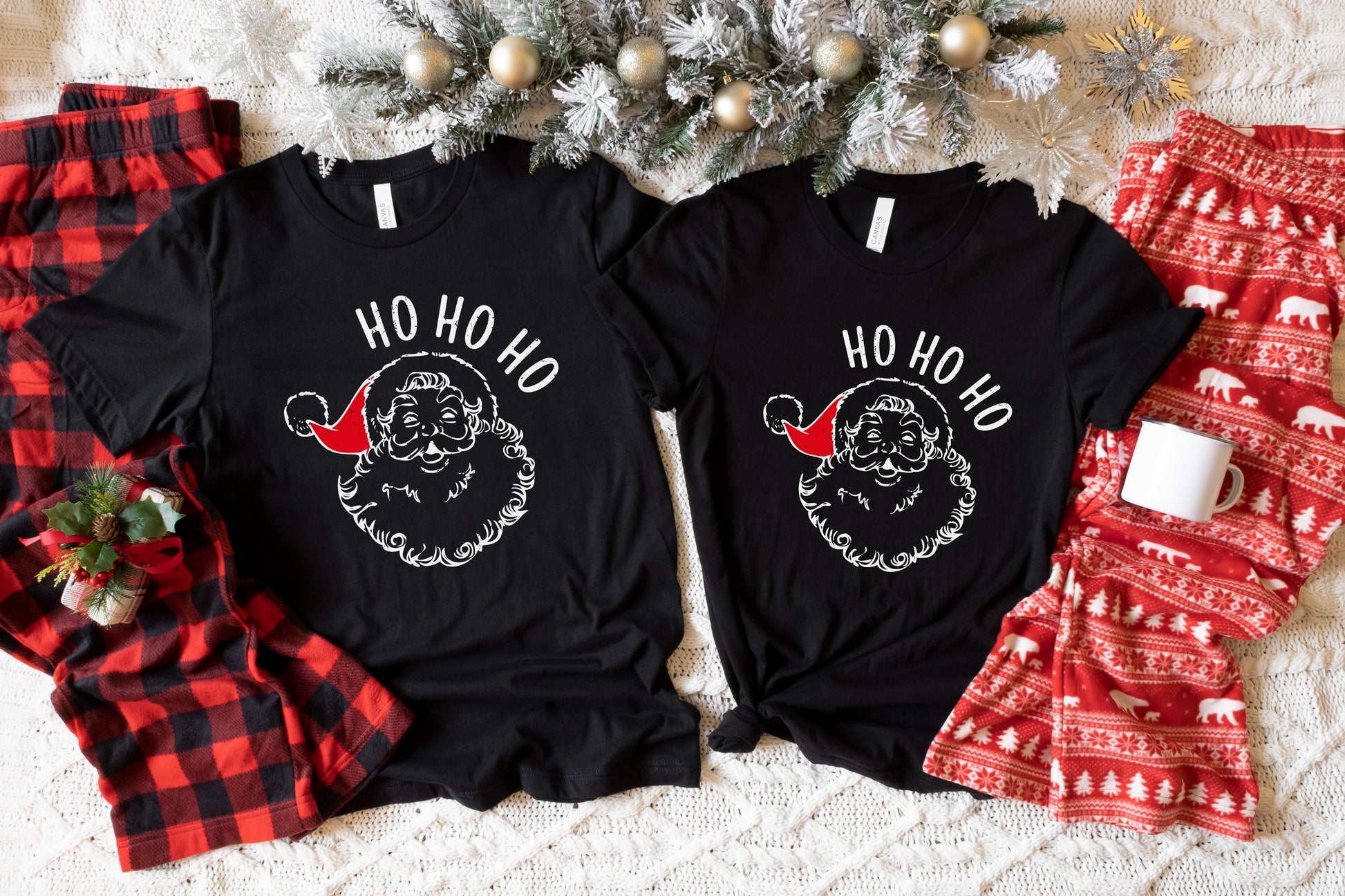 two black t-shirts with a Santa Claus design, along with a pair of red pajama bottoms and a Christmas tree.