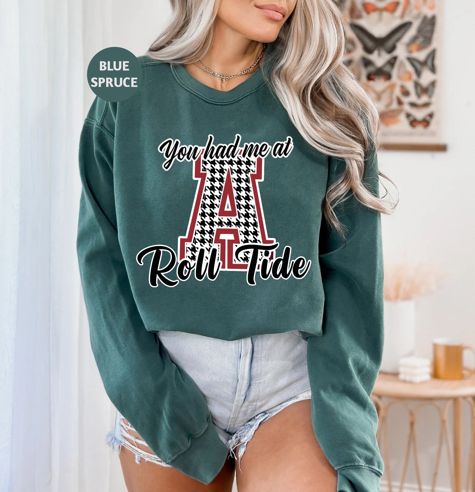 a woman wearing a green sweatshirt with the letter a on it