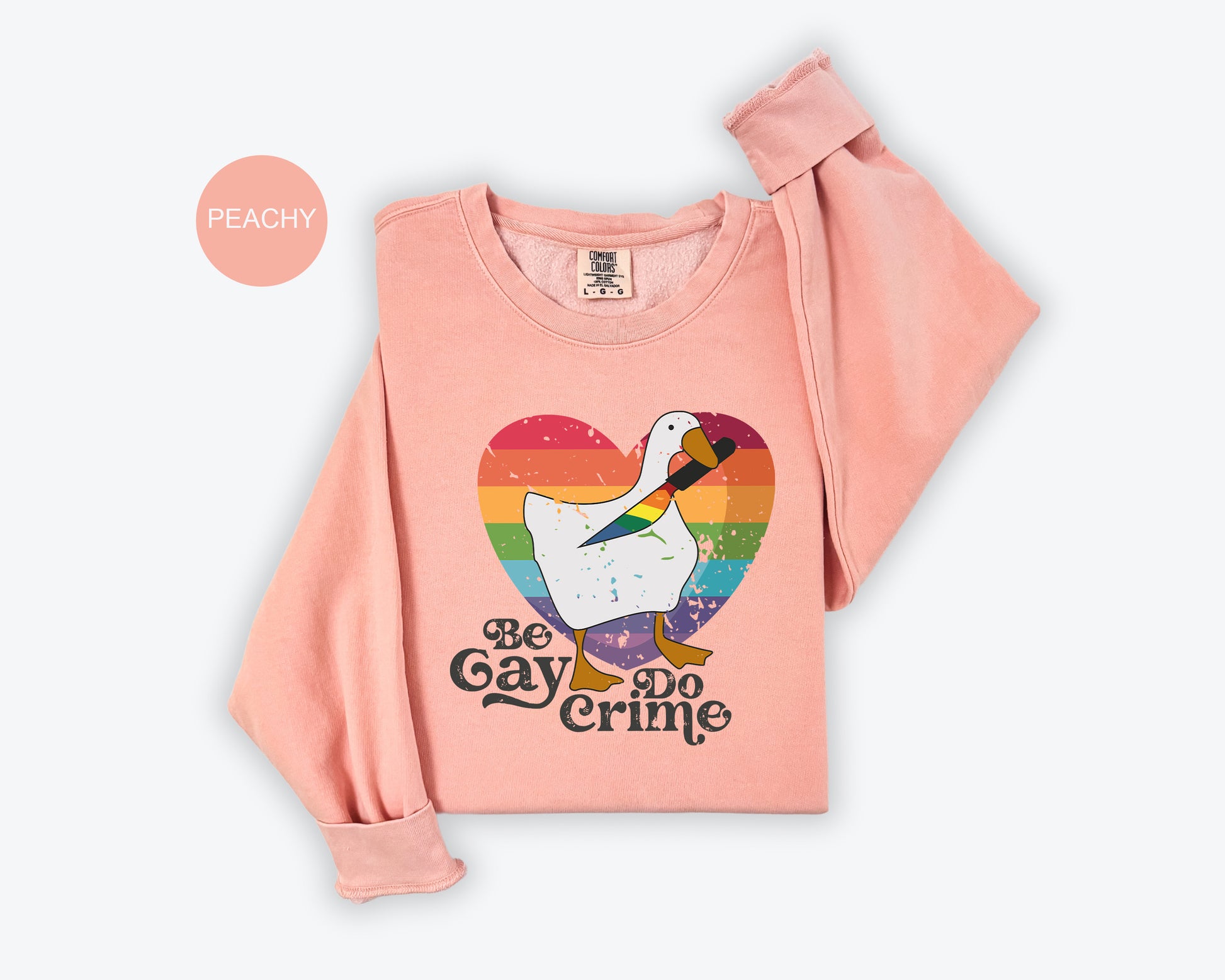 a pink shirt with a white goose on it