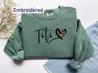 a green sweatshirt with a leopard print on it