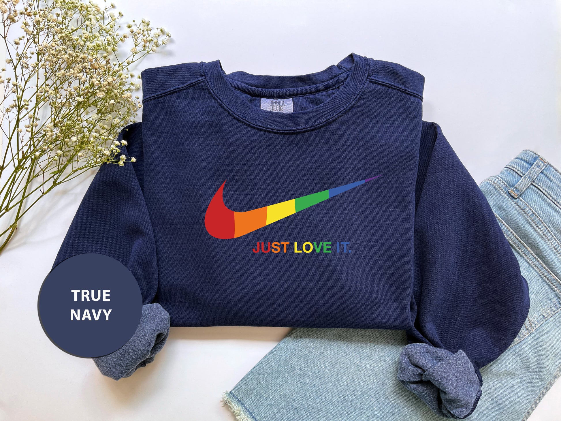 a blue sweatshirt with a rainbow nike logo on it