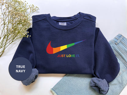 a blue sweatshirt with a rainbow nike logo on it