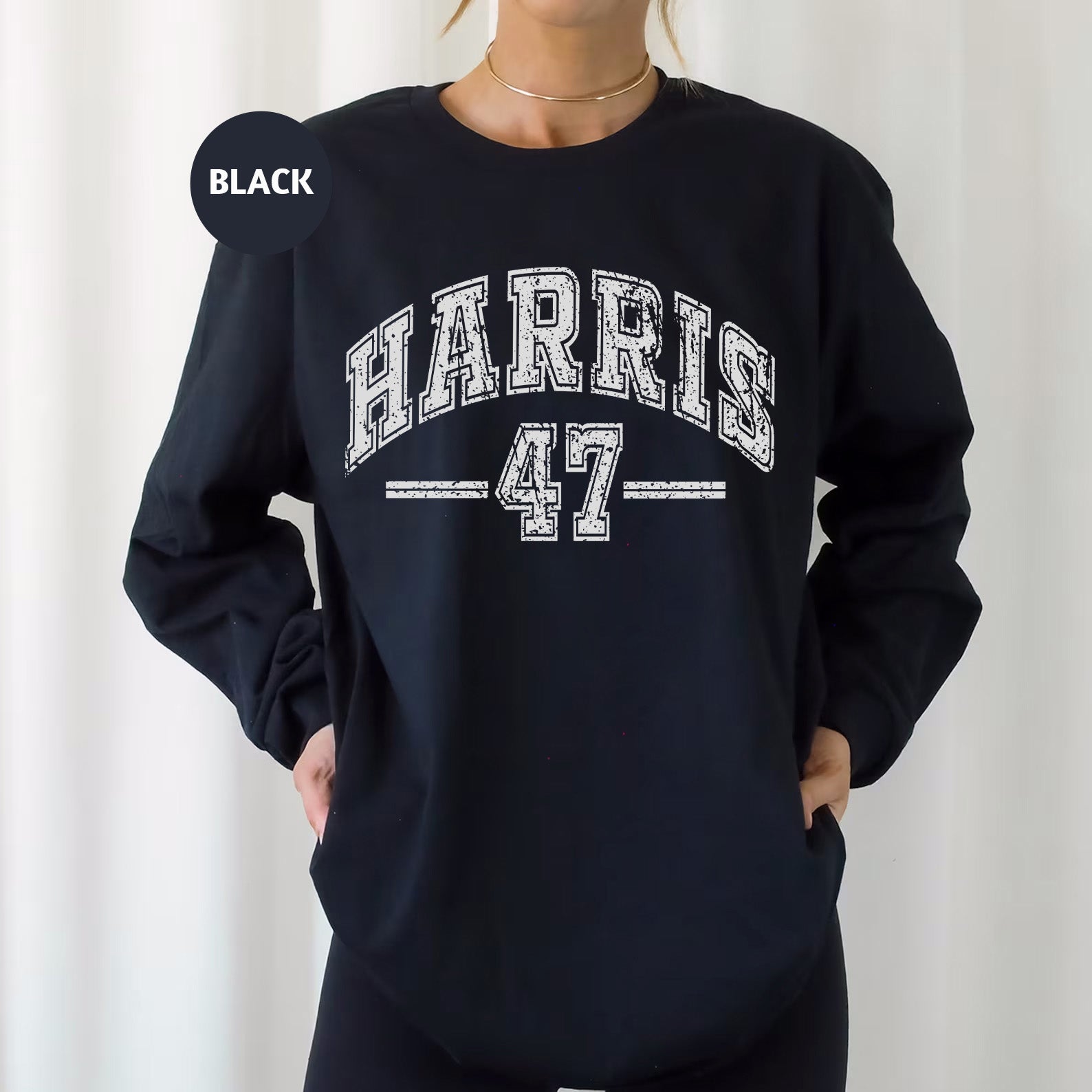 a woman wearing a black sweatshirt with the word harris 47 printed on it