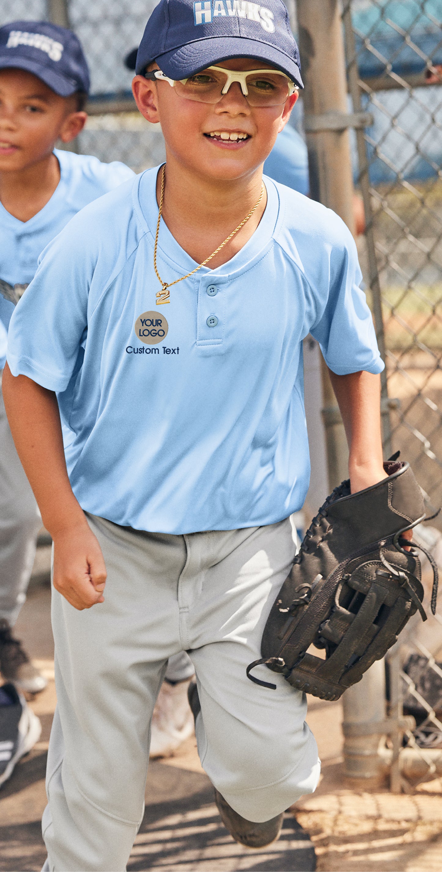 a young boy in a baseball uniform holding a catchers mitt