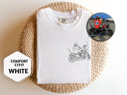 a white t - shirt with a picture of a man on a motorcycle