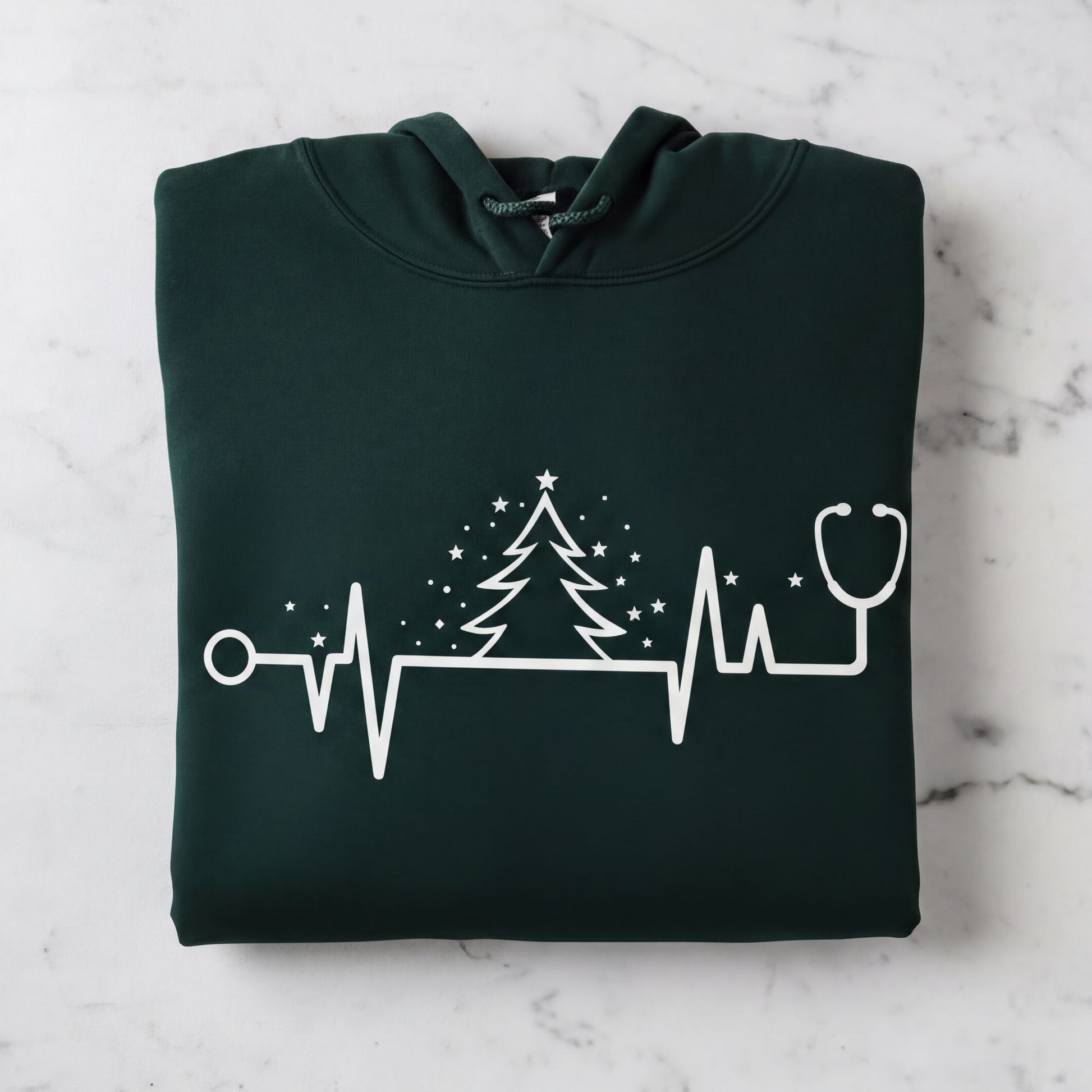 A dark green hoodie with a white graphic design depicting a stethoscope and a Christmas tree with stars.