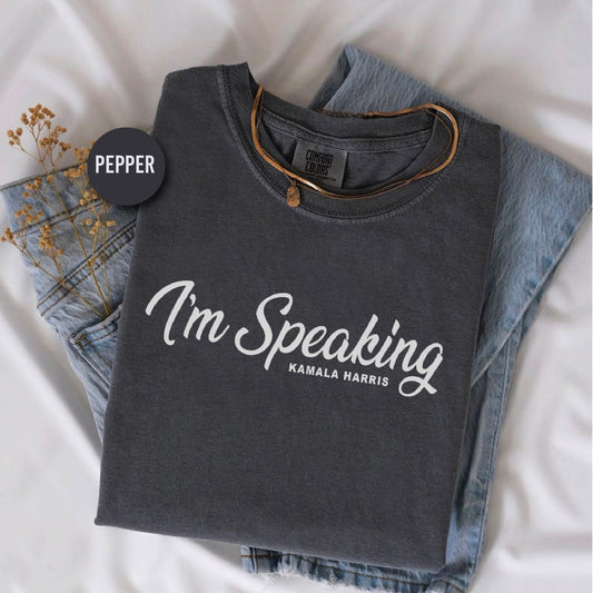 a t - shirt that says i'm speaking on it next to a pair