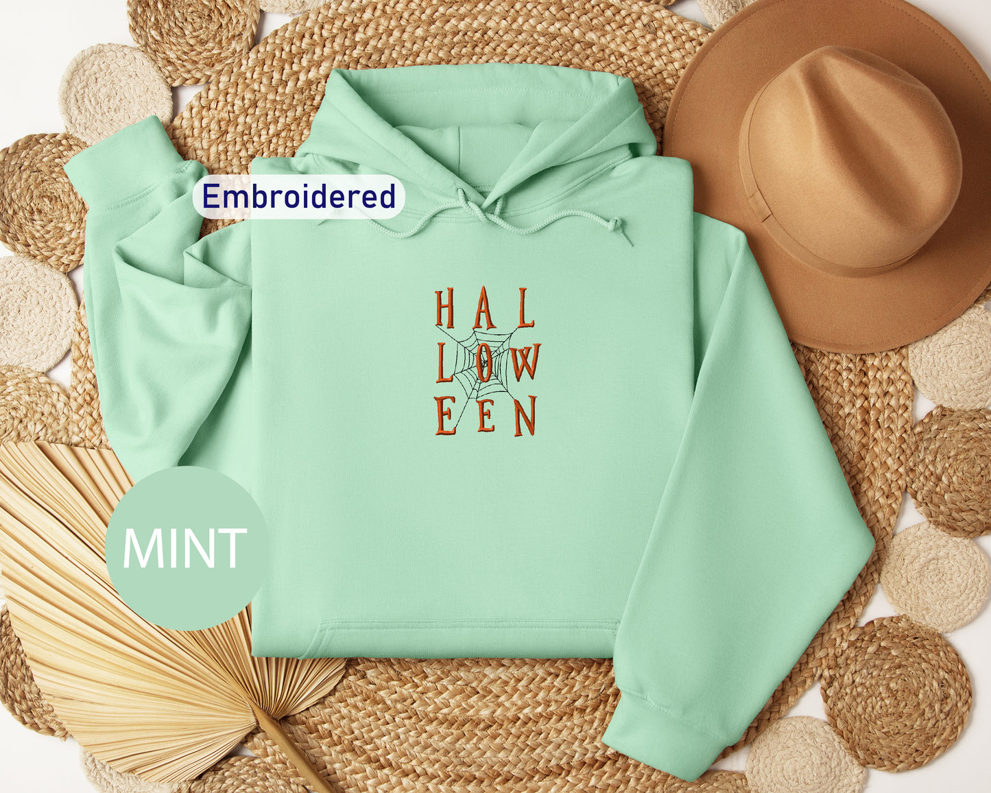 a mint green hoodie with the words hal low een printed on it