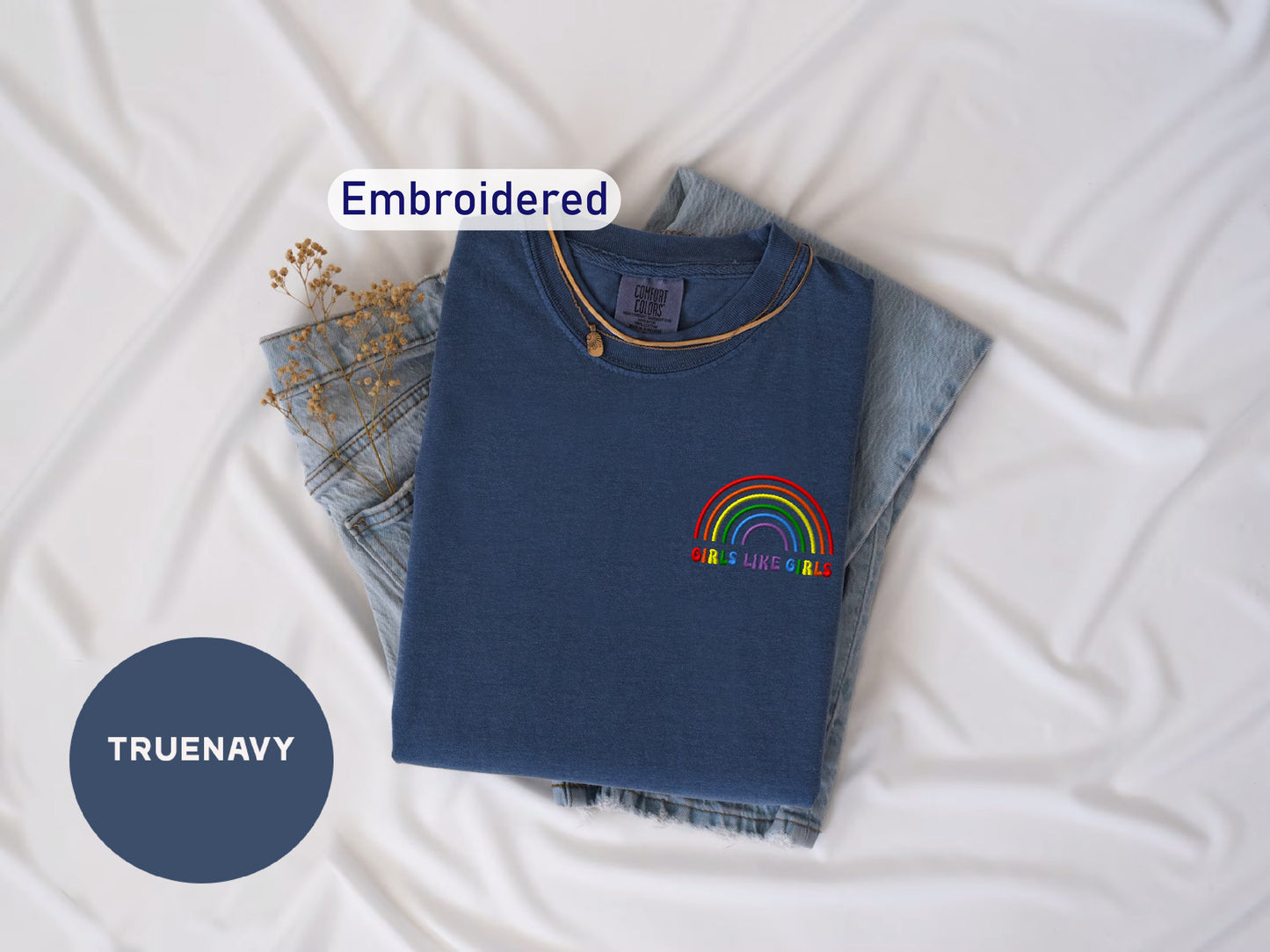 a blue shirt with a rainbow embroidered on it