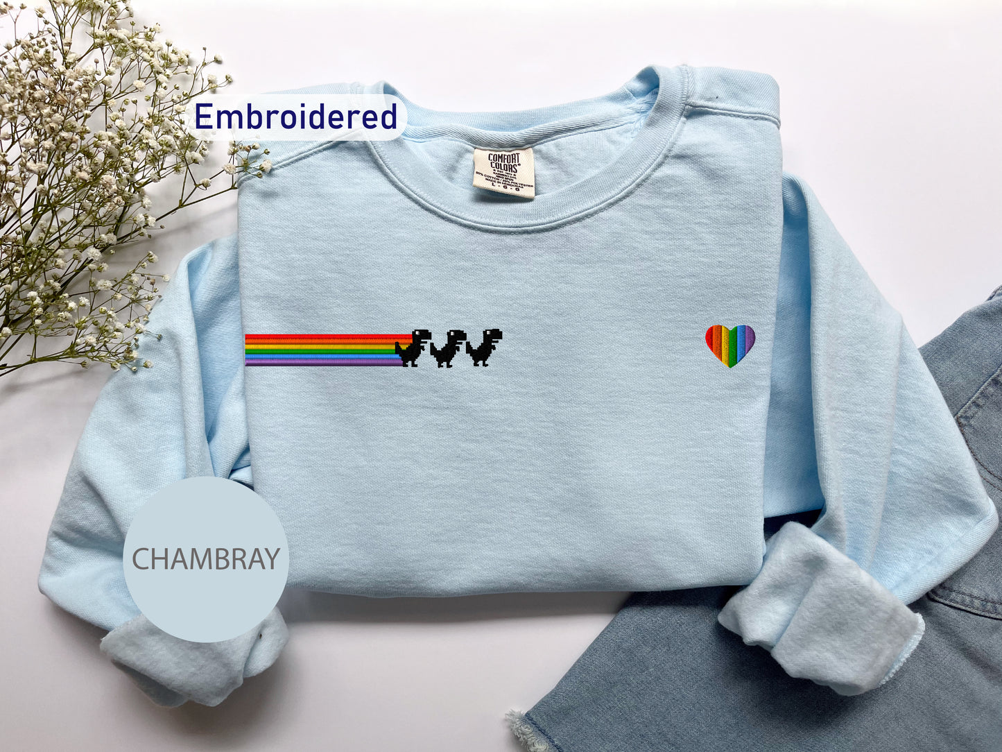 a blue shirt with a rainbow on it