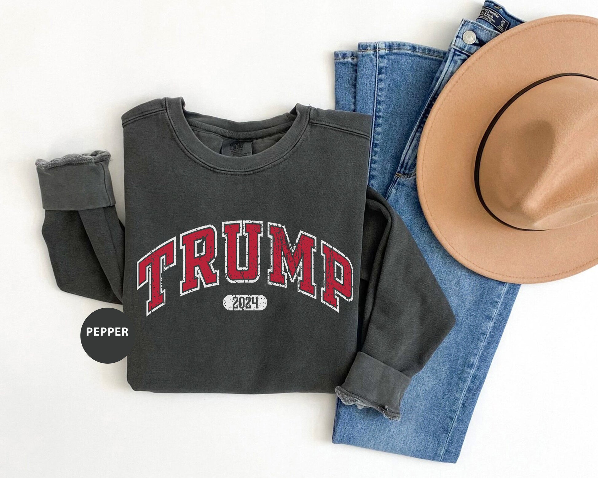 a hat, jeans, and a sweatshirt with the word trump on it