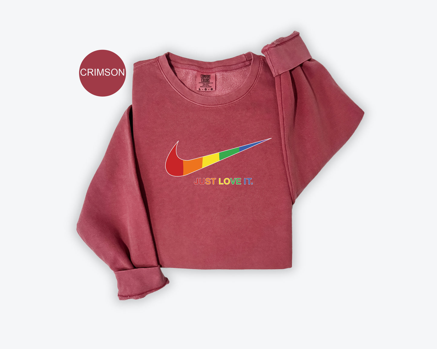 a pink shirt with a colorful nike logo on it