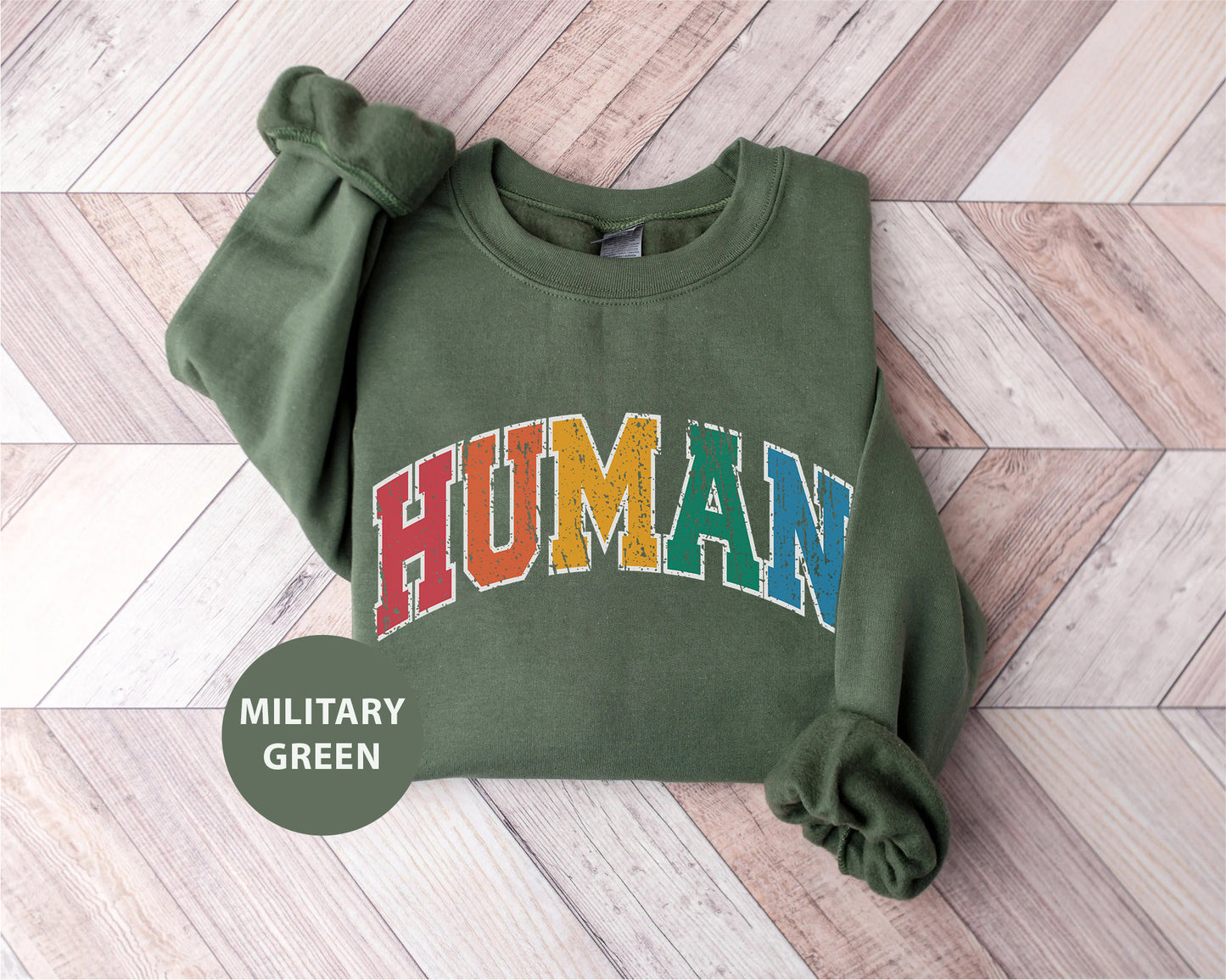 a green sweatshirt with the word human printed on it