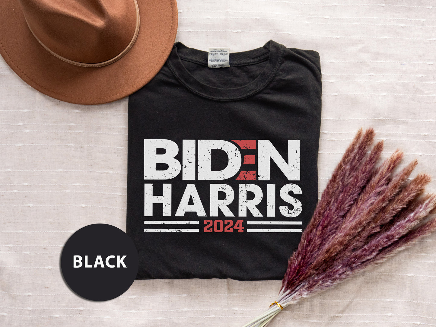 a black shirt with bidn harris on it next to a hat and