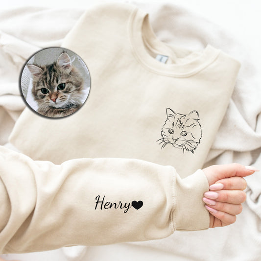 a person holding a baby's hand with a picture of a cat on it