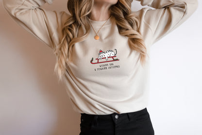 A woman wearing a white sweater with a graphic of a cat on a sled and text that says "Wishing you a happy xmas"