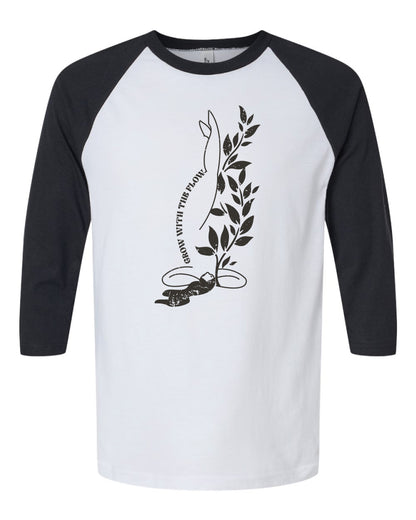 a white and black t - shirt with a plant on it