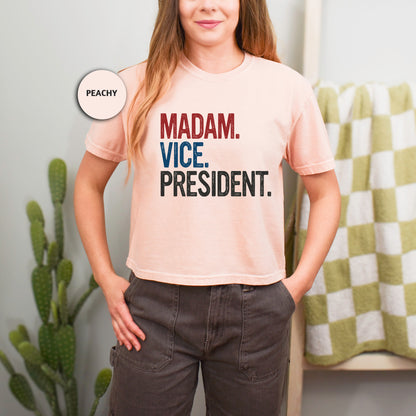 a woman wearing a pink shirt that says madam vice president