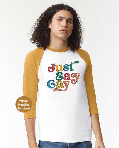 a man wearing a white and yellow shirt with the words just gay on it