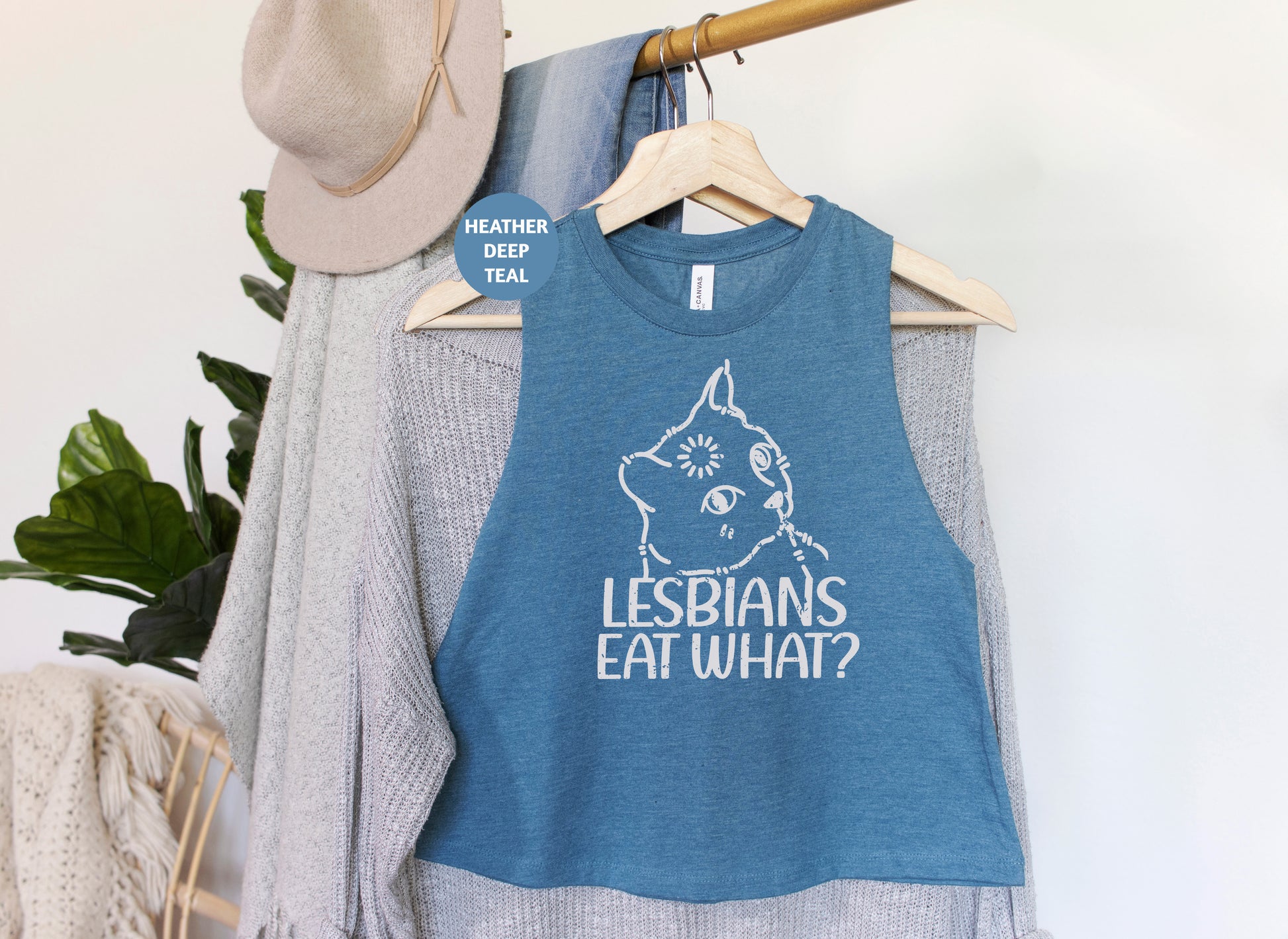 a blue tank top that says lesbians eat what?