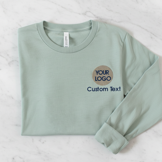 A light green long-sleeve t-shirt with a custom text logo on the left side.