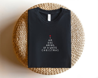 A black t-shirt with white text printed on it, laid out on a woven basket or mat.