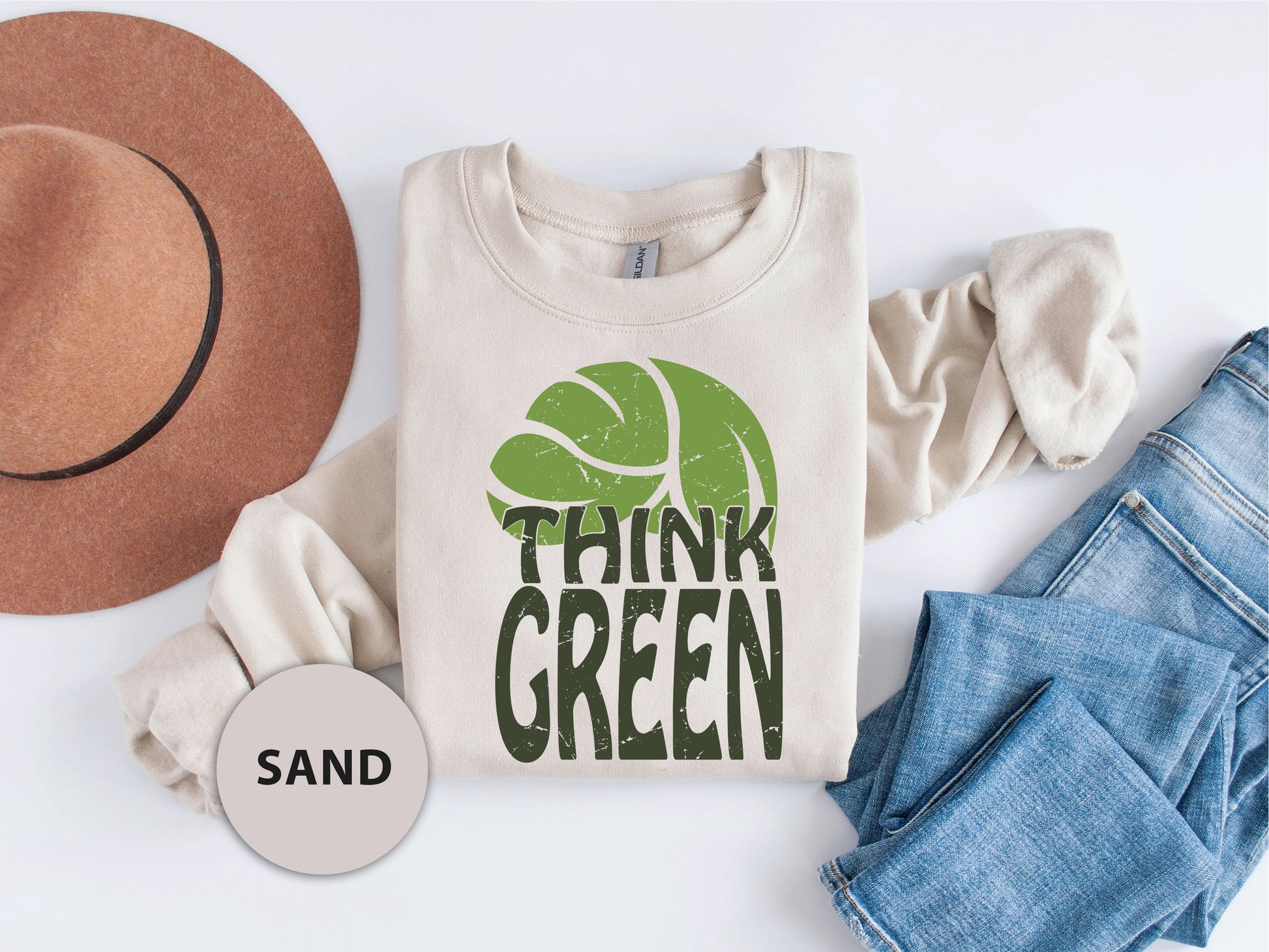 a t - shirt that says think green next to a hat and jeans