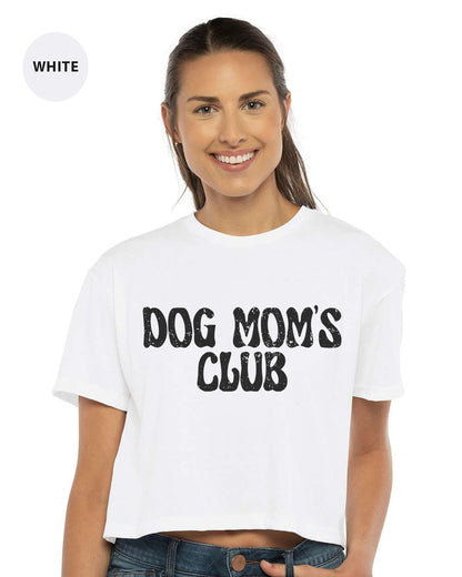 a woman wearing a white dog mom's club t - shirt