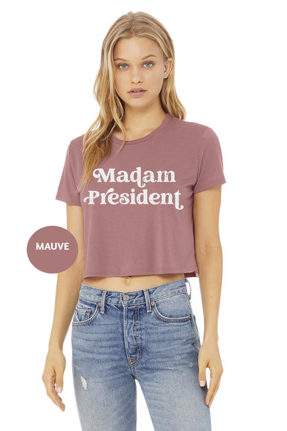 a woman wearing a crop top that says madam president