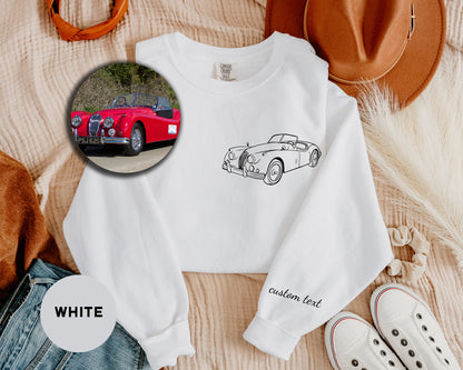 a white shirt with a picture of a red car on it