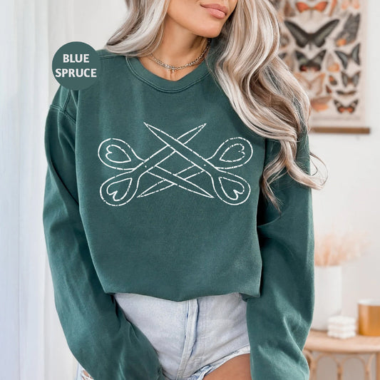 a woman wearing a green sweatshirt with a crossed design