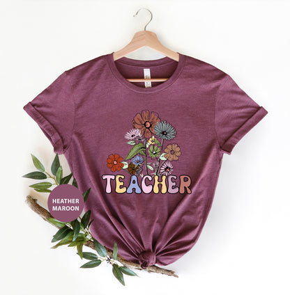 a t - shirt that says teacher with flowers on it