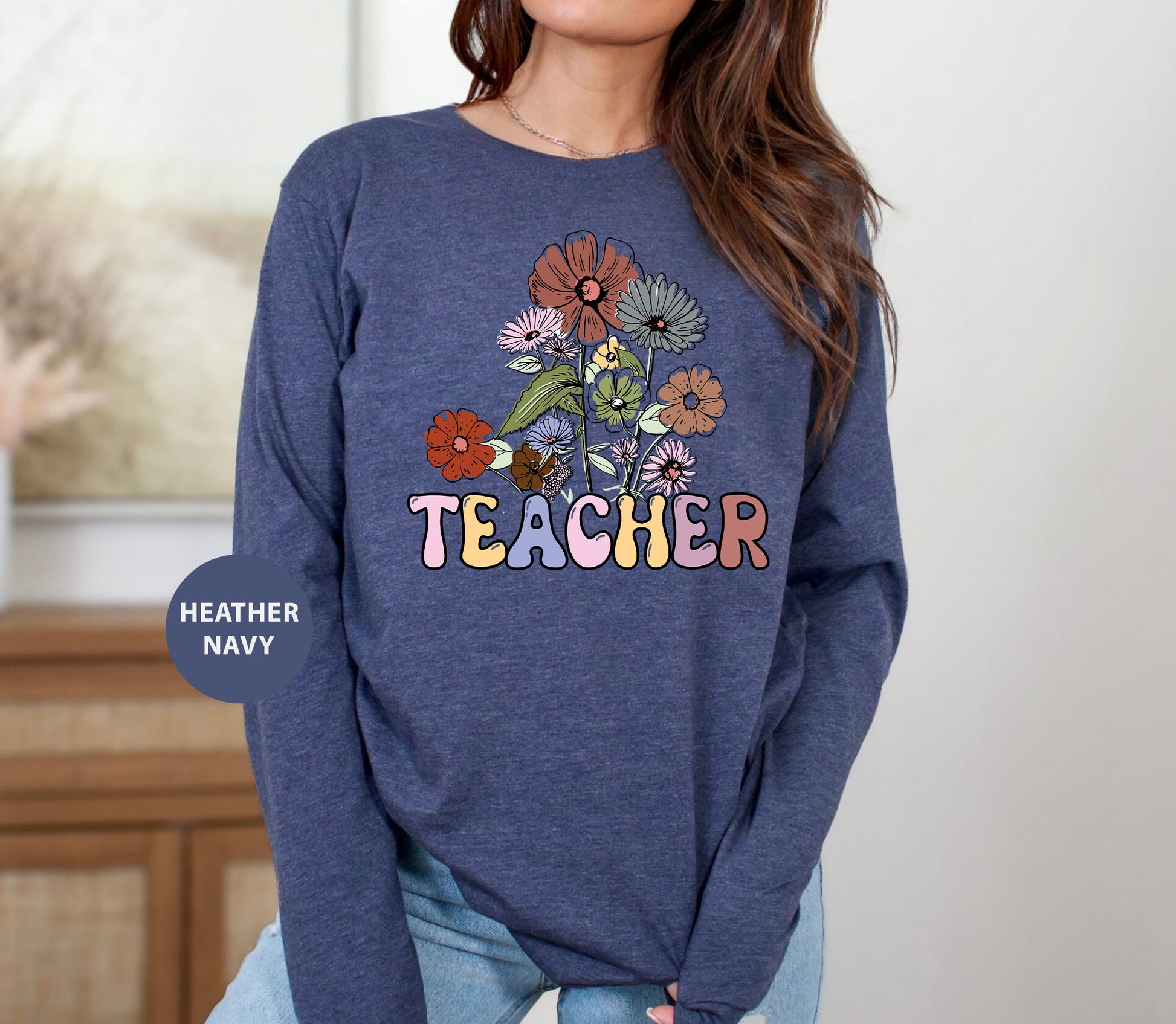 a woman wearing a sweatshirt that says teacher