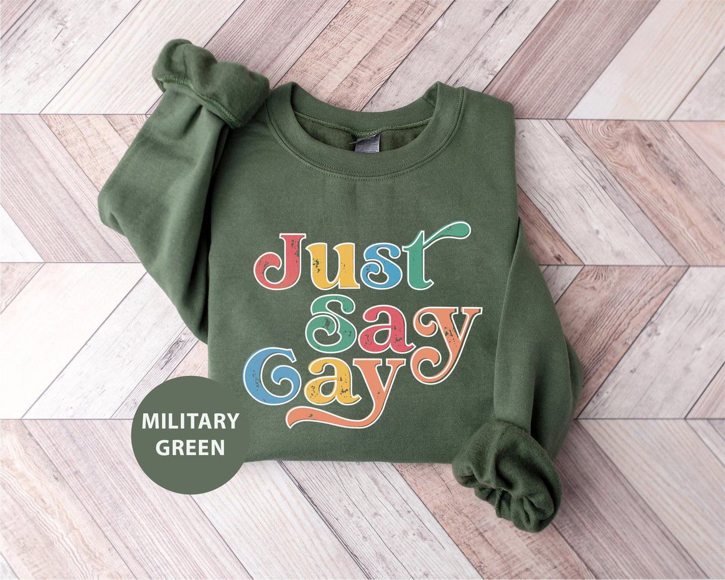 a green sweatshirt with the words just say gay on it