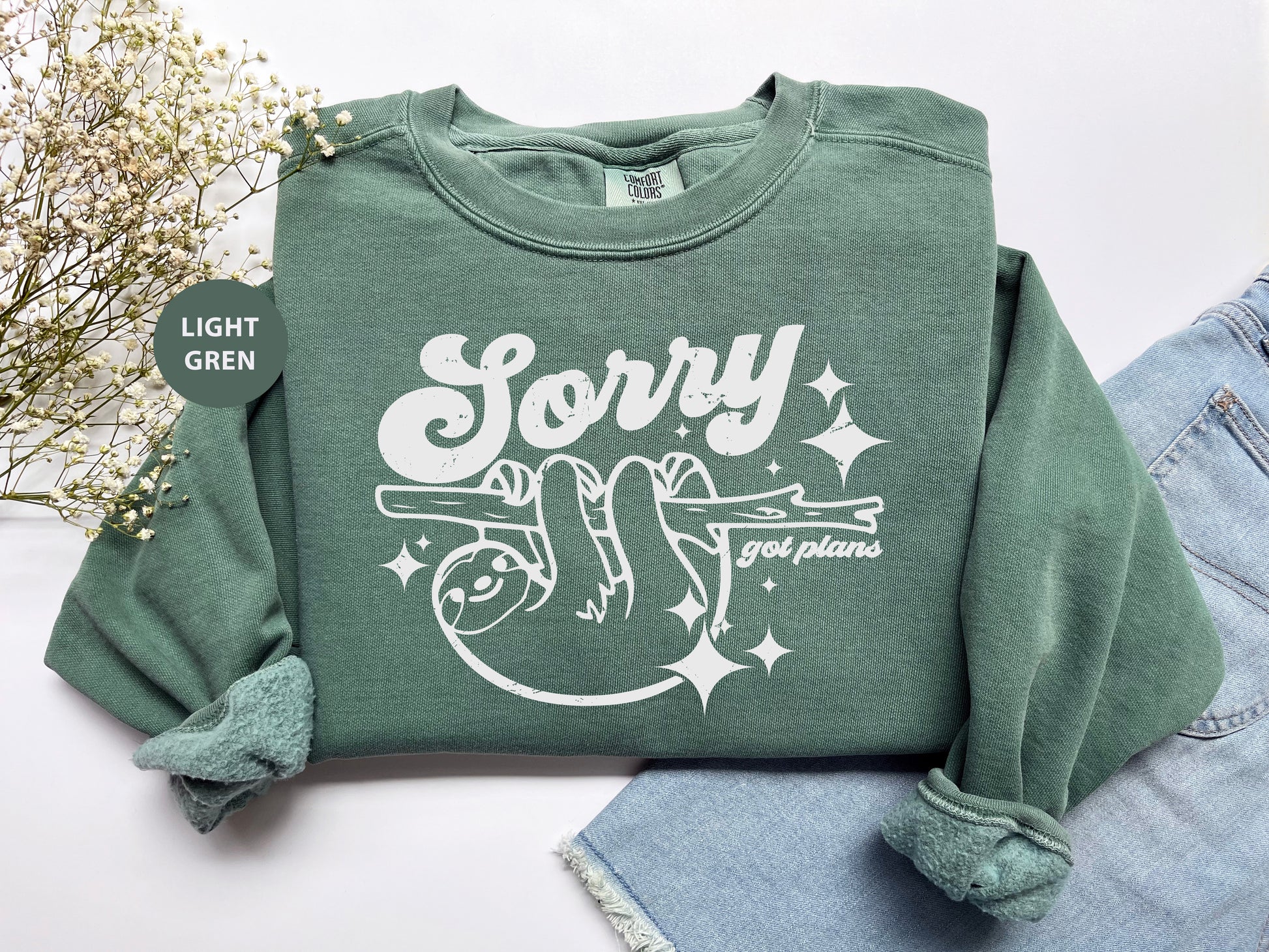 a green sweatshirt with the words sorry on it