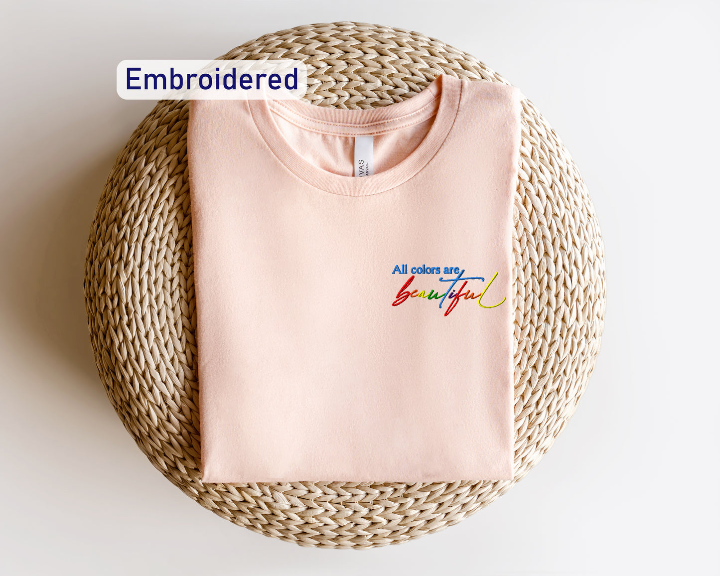 a pink t - shirt with the words embroidered on it