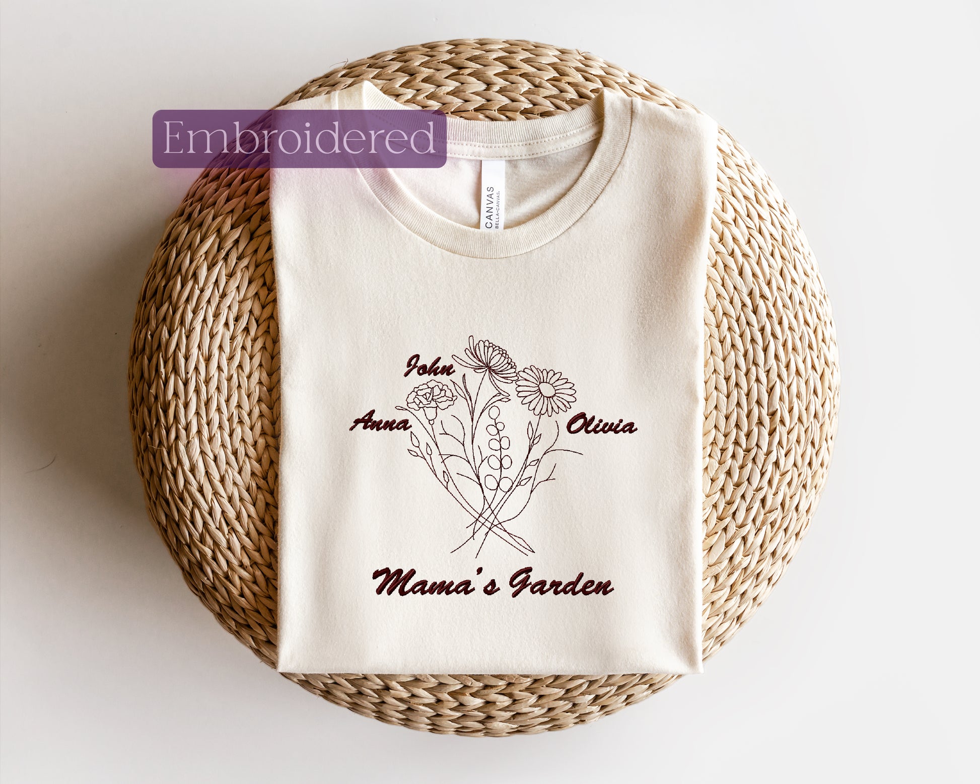 a white t - shirt with the name mama's garden on it