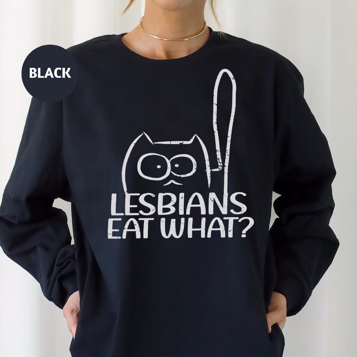 a woman wearing a black sweatshirt that says lesbians eat what?