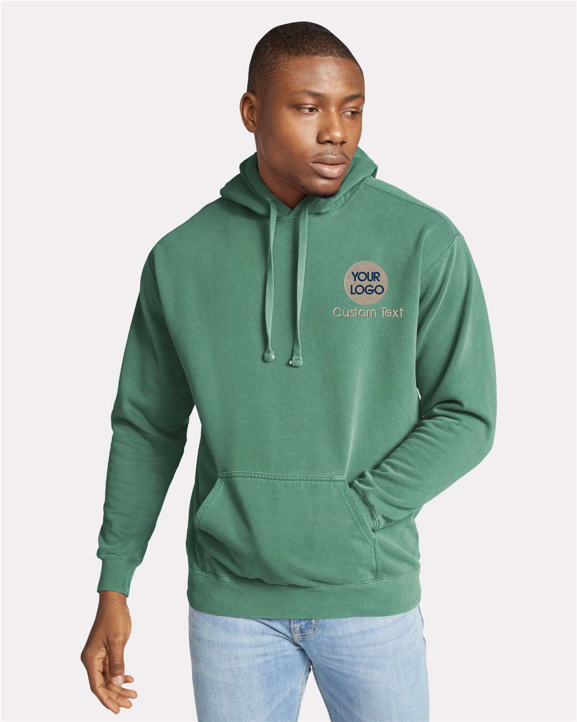 a man wearing a green hoodie with a logo on it