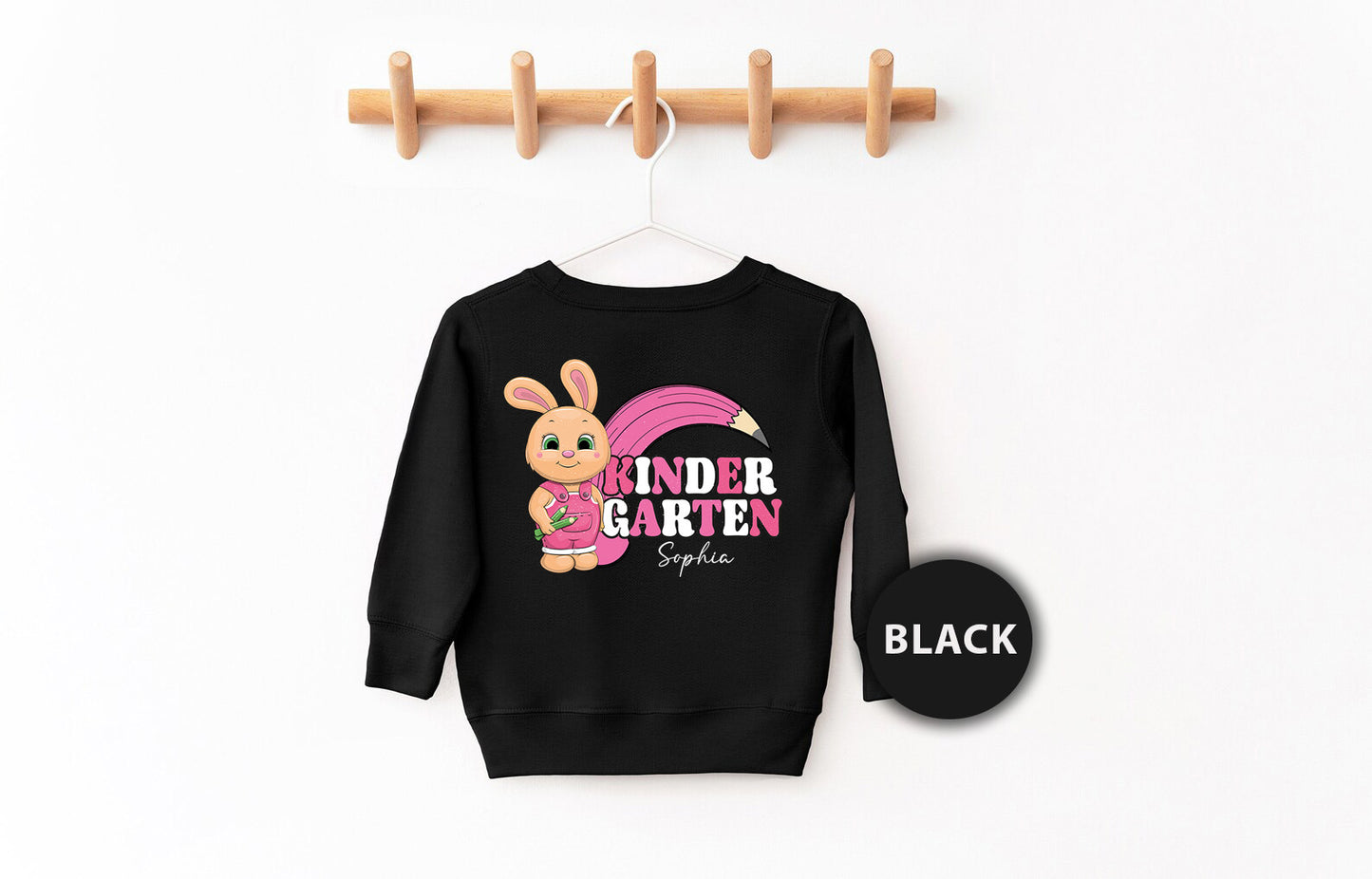 a black sweatshirt hanging on a clothes rack