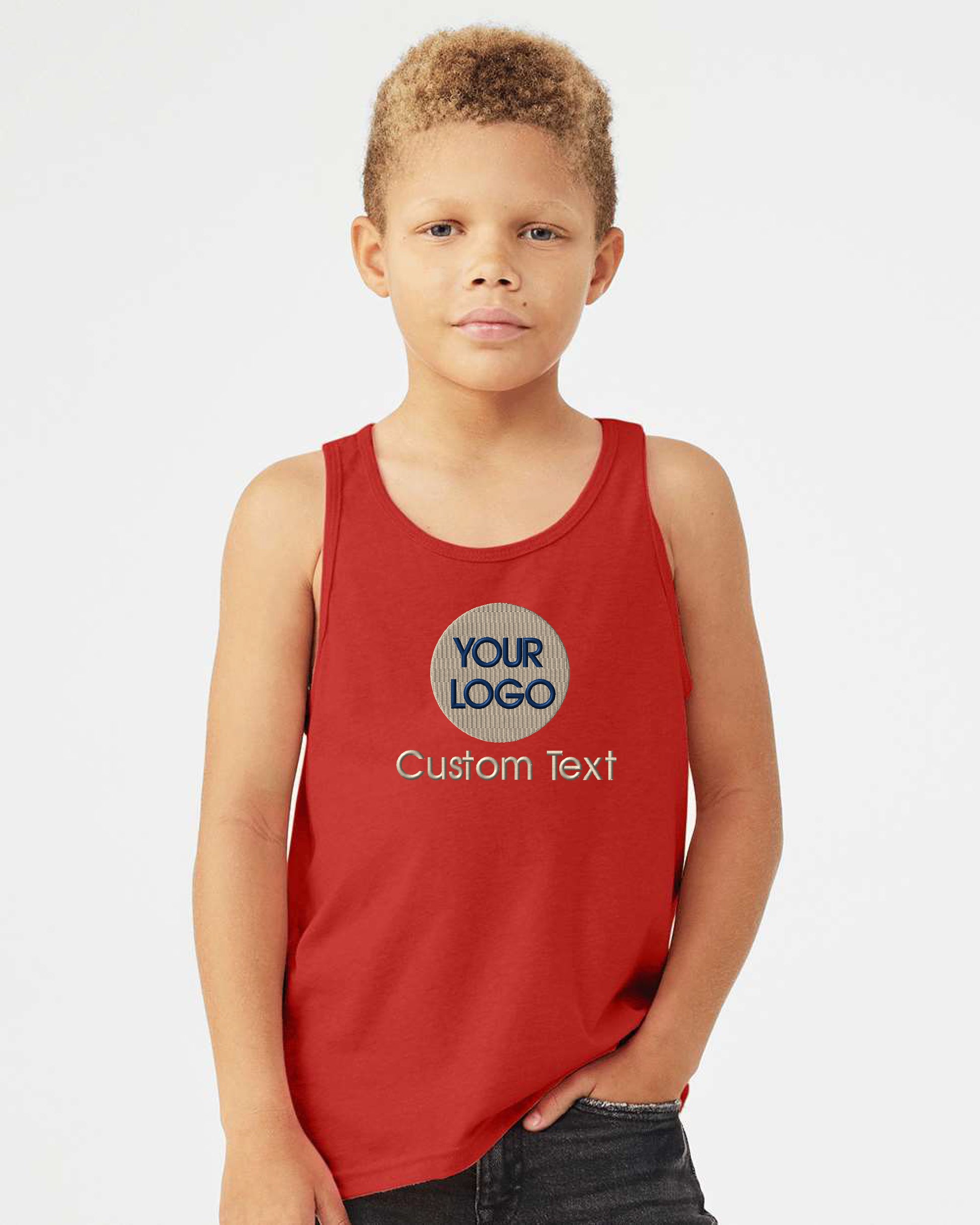 a young boy wearing a red tank top