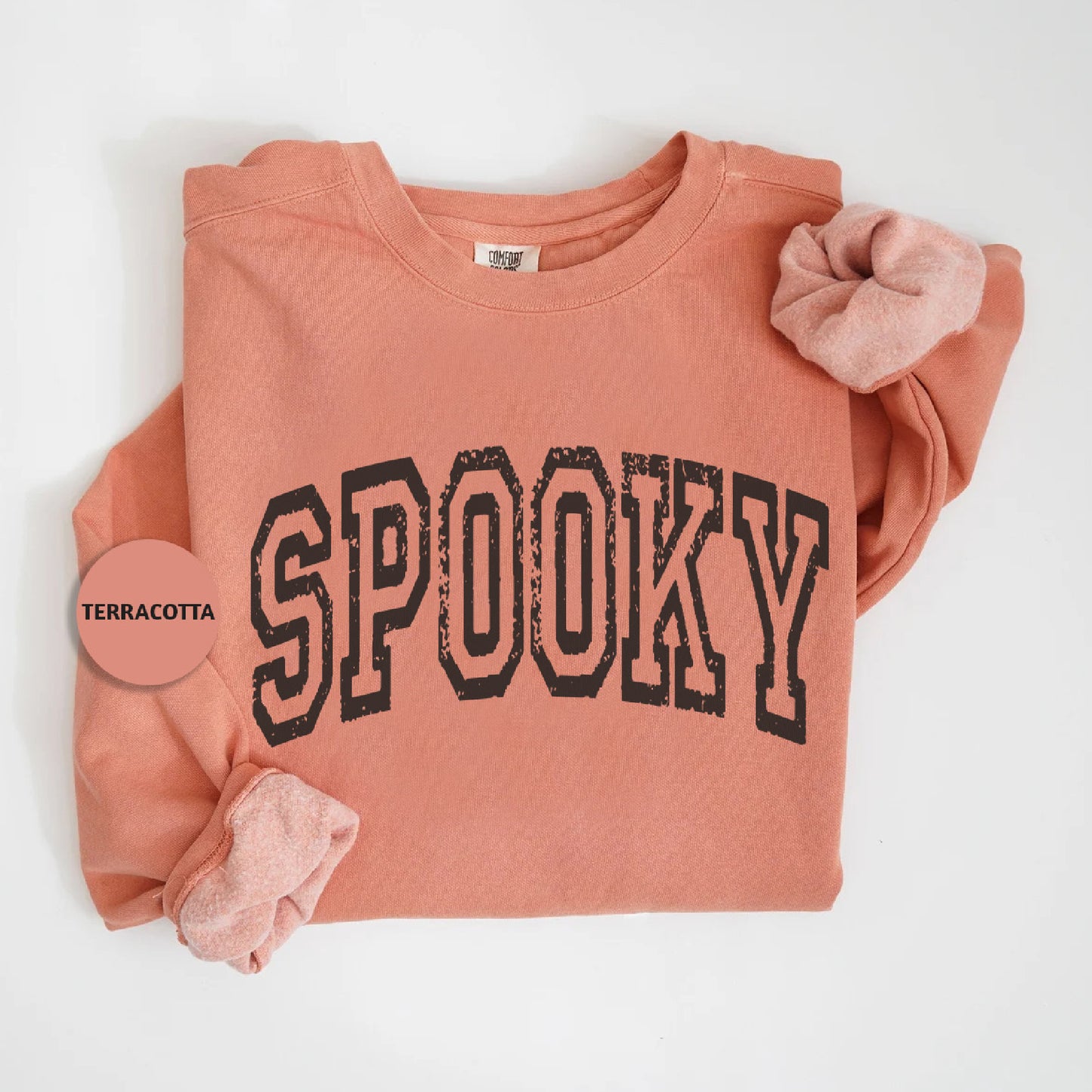 a pink shirt with the word spooky printed on it