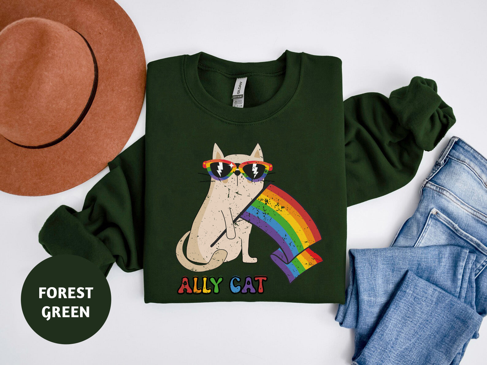 a green shirt with a cat wearing sunglasses and a hat